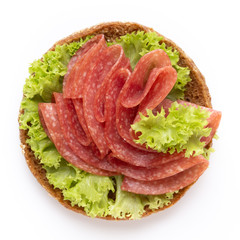 Sandwich with salami sausage on white background.
