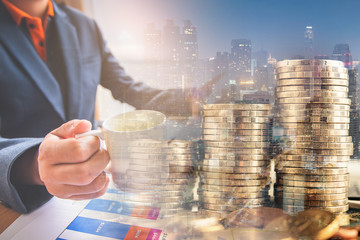 double exposure of businessman working at office with step of golden coins and city night 