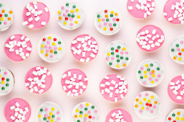 Colorful cupcakes on a white background.