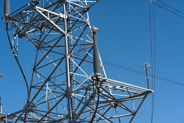 high voltage power line tower sky closeup