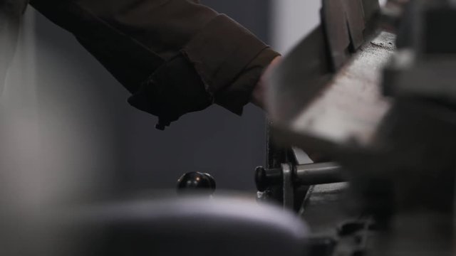 Unrecognizable person works on outer diameter grinder