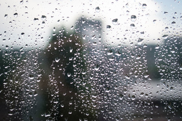 Creative idea for background. Raindrops on the glass against the sky