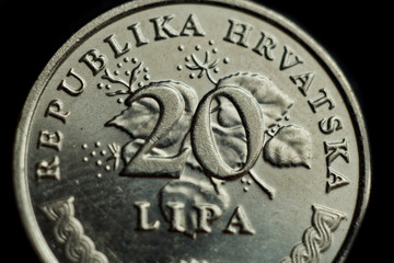 coin twenty croatian lipa macro isolated on black background. Detail of metallic money close up. money of european country croatia