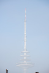 Radio and TV tower almost disappearing in the early morning haze