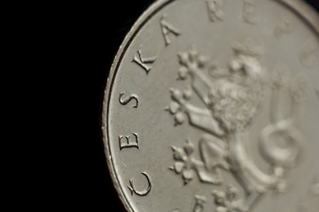 One Czech koruna coin close-up isolated on black background. Detail of metallic money close up. European country money Czech Republic