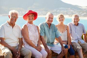 Portrait Of Senior Friends Visiting Tourist Landmark On Group Vacation