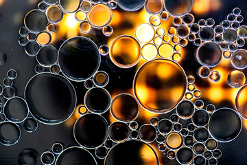 Black and golden bubbles on water