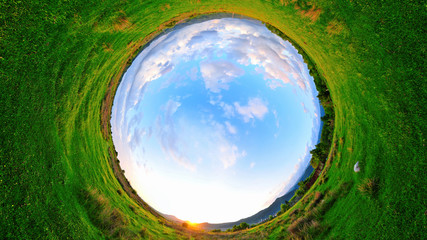 Stereographic panoramic projection of a green field in the summer. 360 degree panorama.