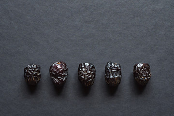 Ajwa Al-Madina dates fruits are laid out on a black table