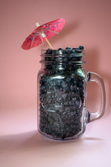 Jar of blueberries on a pink background 2