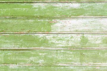 Background from a vintage wood painted in green paint with scuffs