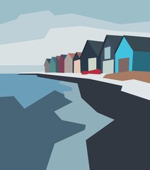 Beautiful small houses standing on the blue sea shore. Minimalistic landscape with buildings in front of the sea in the evening