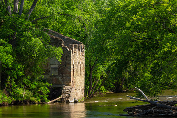Fototapeta na wymiar Mill Ruins By A River In The Woods