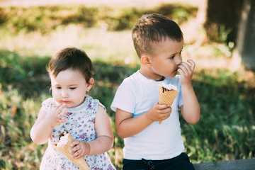 Cute kids Brother and sister Eating ice cream in summer outside is very cute