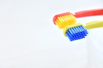 Two bright toothbrushes with soft focus on blurred neutral background. Plastic toothbrush for personal daily oral hygiene. Dental healthcare. Tools for morning routine. Caries protection Instrument 