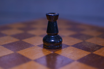 Black chess rook in the foreground