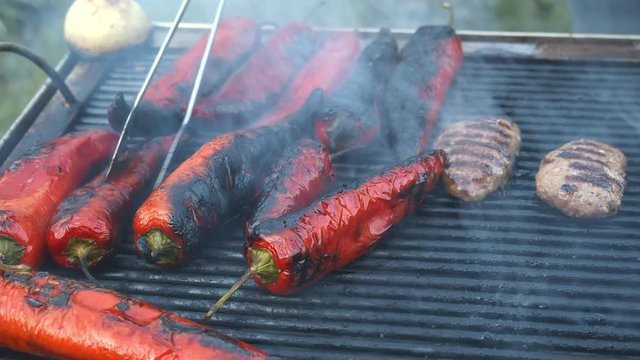 Meat balls and red paper on the grill.