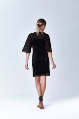 Fototapeta premium Beautiful sexy young business woman blond hair with evening make-up wearing a dress suit top and high-heeled shoes business clothes for meetings and walks autumn collection perfect body shape.