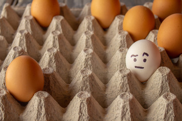 Eggs with funny faces drawn. Concept of diversity and moods.