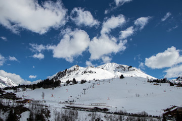 Fototapeta na wymiar Ski lifts leading up the mountain. Big white mountain in alps.