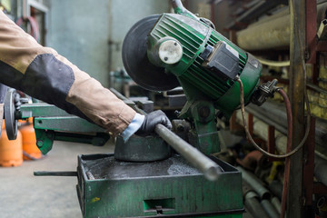 Cutting the metal pipes on a circular saw