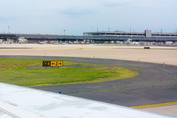 Close Up of Wing of Airplane on Blur Runway at the Airport