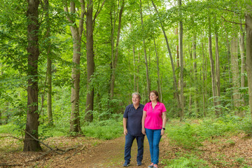 Obraz premium Couple Enjoying the walk in the forest
