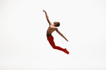 Fototapeta na wymiar Graceful classic ballet dancer dancing isolated on white studio background. Man in bright red clothes like a combination of wine and milk. The dance, grace, artist, movement, action and motion concept