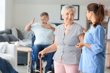 Elderly woman with caregiver in nursing home