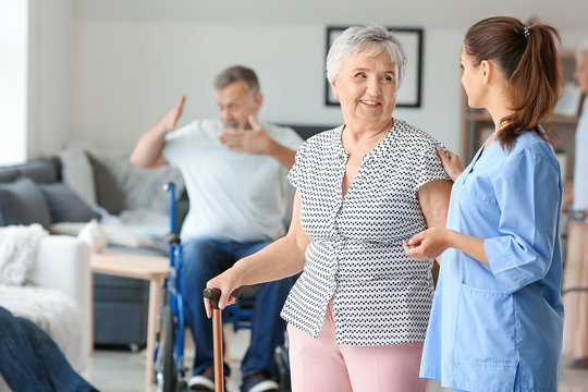 Elderly Woman With Caregiver In Nursing Home