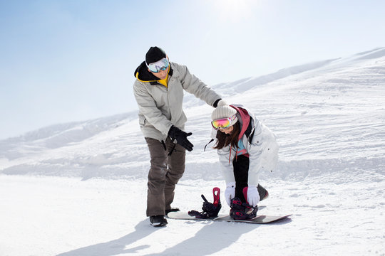Happy young couple skiing in ski resort