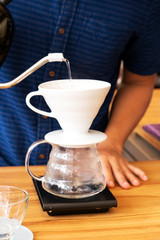 Barita is making coffee in the shop.