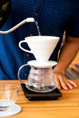 Barita is making coffee in the shop.