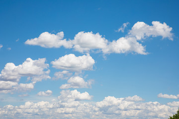 White, fluffy clouds in blue sky. Background from clouds.