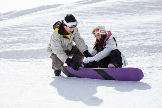 Happy young couple skiing in ski resort