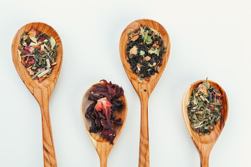 leaf  tea in a wooden spoon isolated on white background