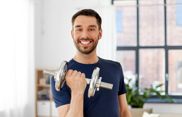 fitness, sport, weightlifting and bodybuilding concept - man exercising with dumbbell at home