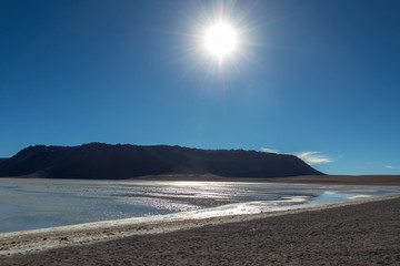 Beautiful background with Altiplanic Lagoon, a shallow saline lake and blue sky
