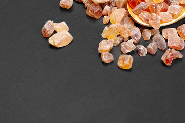 brown sugar rock organic crystalline close up on dark background