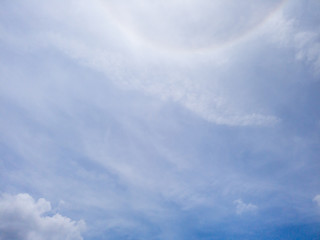 Fototapeta premium Cloudscape of Blue sky and clouds in shining sun with lens flare.