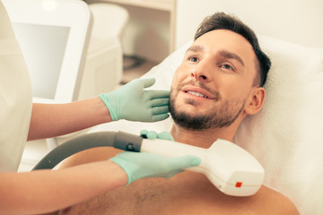 Young man looking confident at the laser hair removal procedure