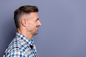 Obraz premium Close-up profile side view portrait of his he nice attractive well-groomed cheerful cheery bearded guy wearing checked shirt copyspace isolated over gray blue violet purple background