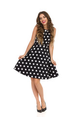 Beautiful Young Woman Is Posing In Black Cocktail Dress In Polka Dots