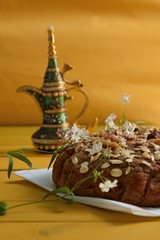 Vegan homemade pie made of integral flour without sugar on a yellow background decorated with gypsophila plant