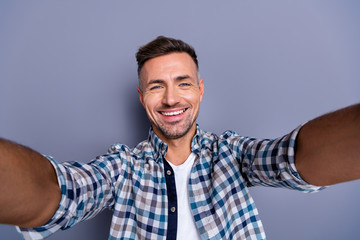Self-portrait of his he nice-looking attractive well-groomed cheerful cheery bearded guy wearing checked shirt isolated over gray blue pastel background
