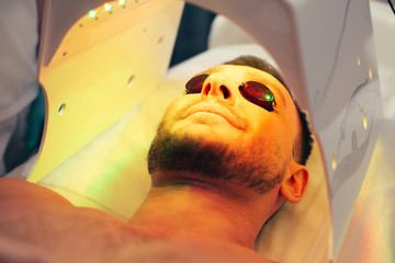 Bearded man smiling in the modern solarium