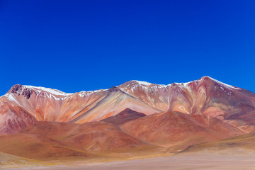 Naklejka premium Background with barren desert scenery in the Bolivian Andes, in the Nature reserve Edoardo Avaroa