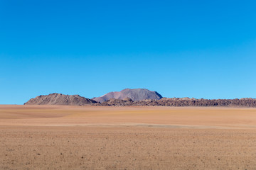 Background with barren desert scenery in the Bolivian Andes, in the Nature reserve Edoardo Avaroa