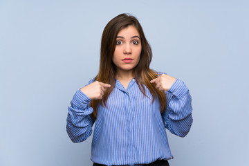 Young girl over isolated blue wall with surprise facial expression