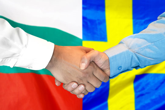 Business handshake on the background of two flags. Men handshake on the background of the Bulgaria and Sweden flag. Support concept